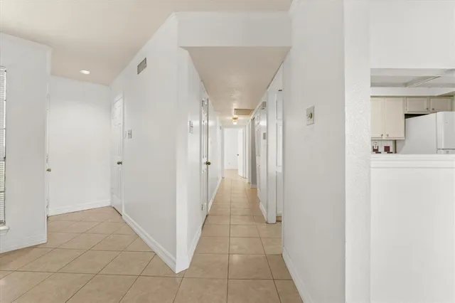 a view of a hallway with a dining area