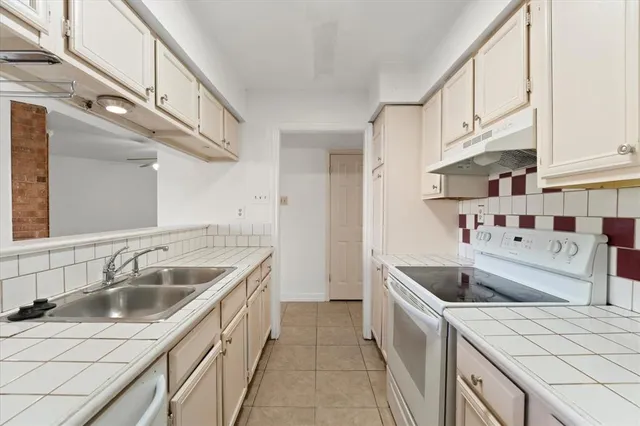 a kitchen that has a sink and a stove