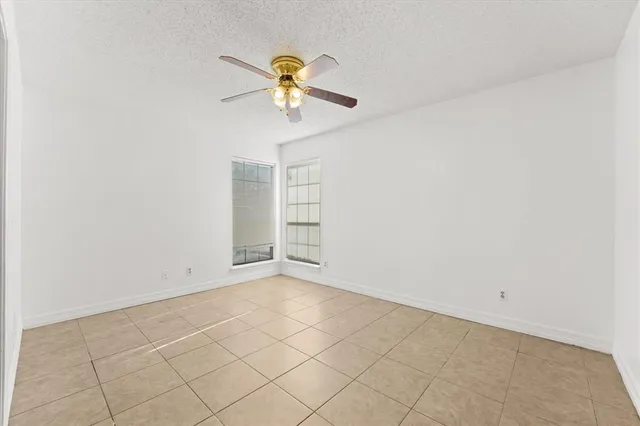 an empty room with a empty space and a ceiling fan