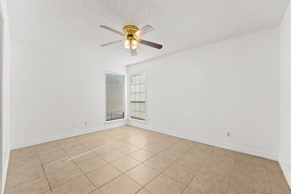 16301 Ledgemont Lane, Unit 109 Addison, TX 75001 - Photo 19 of 32 an empty room with a empty space and a ceiling fan