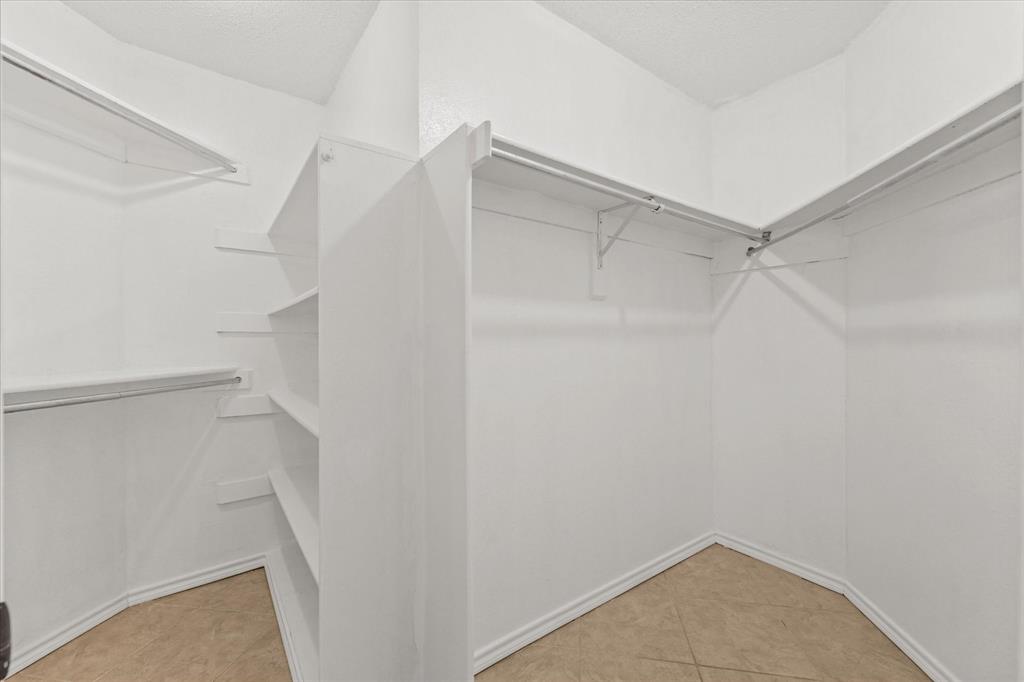 16301 Ledgemont Lane, Unit 109 Addison, TX 75001 - Photo 23 of 32 a view of walk in closet with empty racks