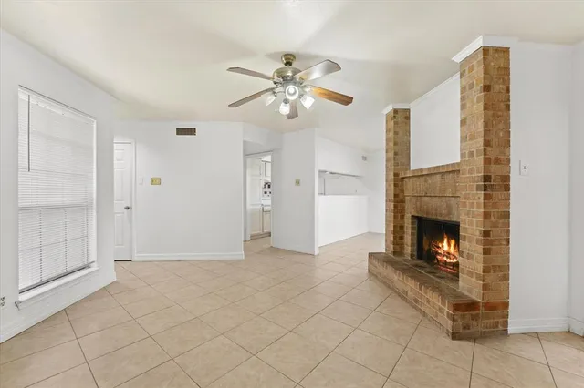 a view of a livingroom with a fireplace and window