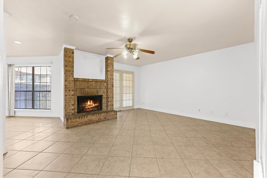 16301 Ledgemont Lane, Unit 109 Addison, TX 75001 - Photo 9 of 32 an empty room with windows and fireplace