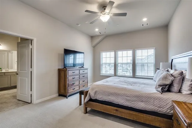 a bedroom with a bed and ceiling fan