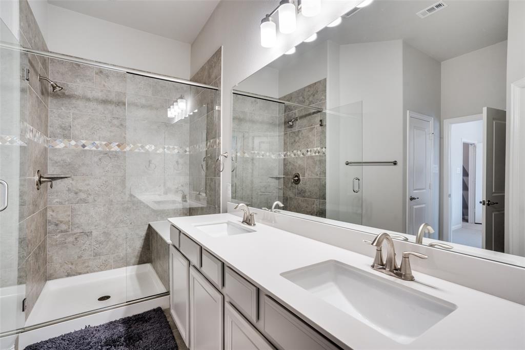 5622 Niagara Road The Colony, TX 75056 - Photo 20 of 28 a bathroom with a sink double vanity and shower