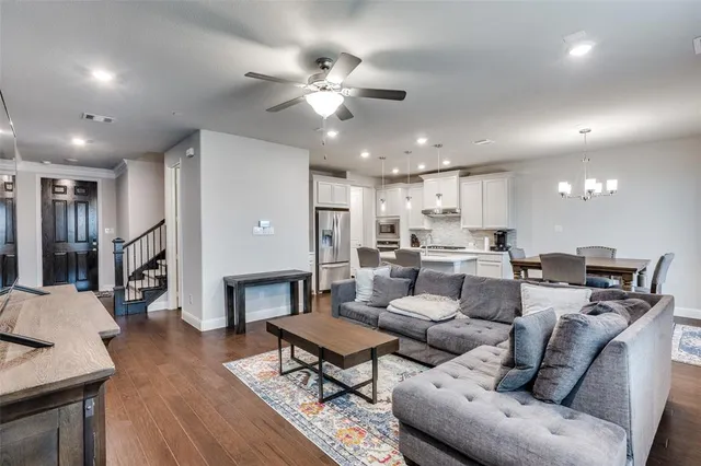 a living room with furniture kitchen view and a fireplace