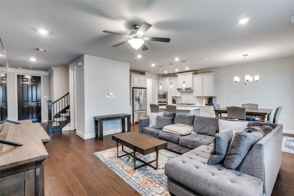 5622 Niagara Road The Colony, TX 75056 - Photo 2 of 28 a living room with furniture kitchen view and a fireplace