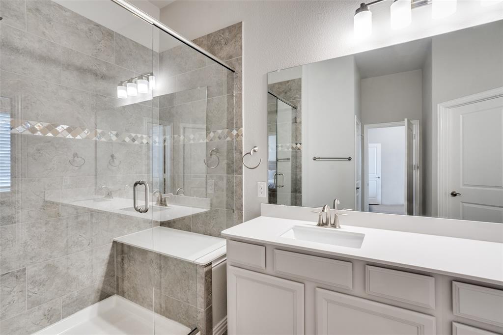 5622 Niagara Road The Colony, TX 75056 - Photo 21 of 28 a bathroom with a sink double vanity and shower