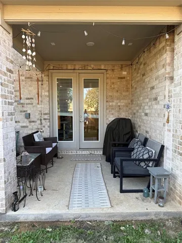 a view of a backyard with a garden and wooden fence