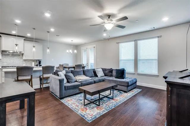a living room with furniture and wooden floor