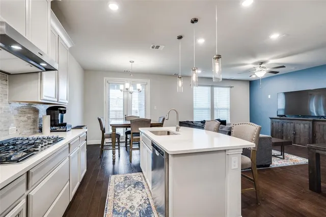 a kitchen with a stove a sink and a refrigerator