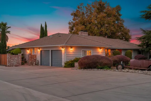a front view of a house with a yard and outdoor seating