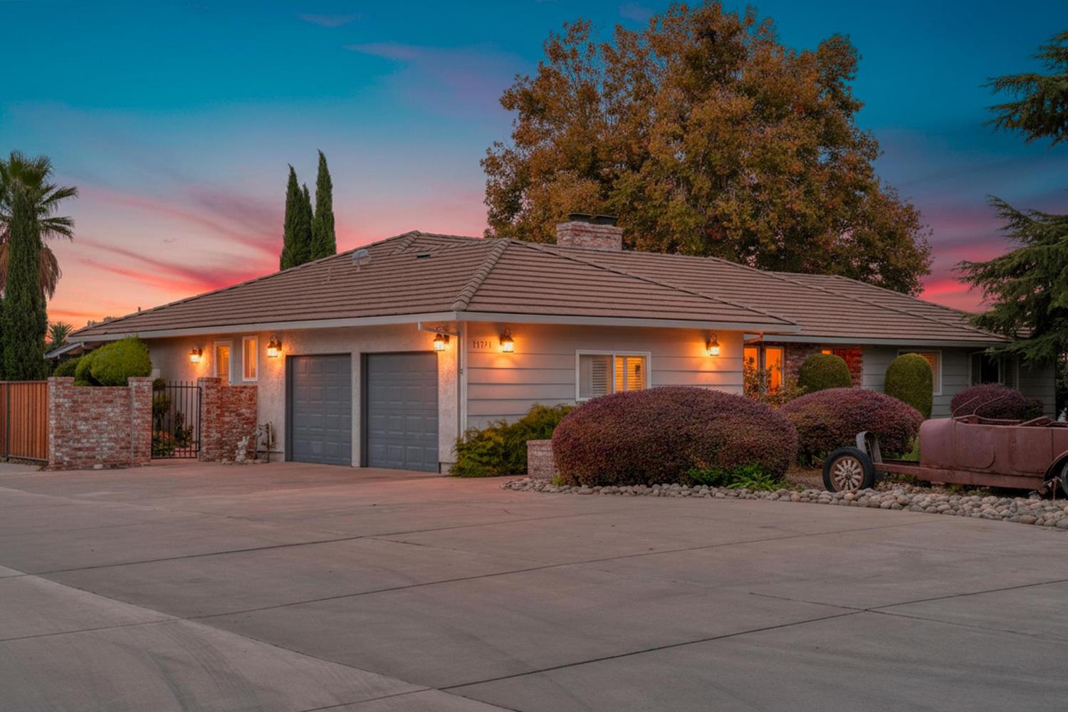 a front view of a house with a yard and outdoor seating