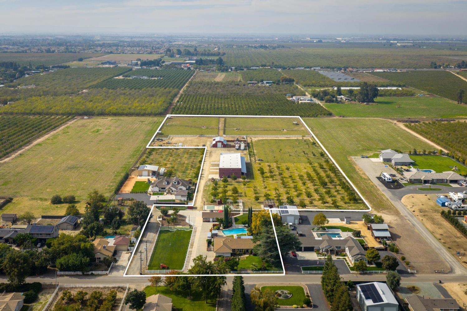 Aerial view with abundant farmland and property parcel outlined