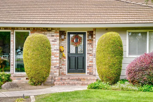 a kitchen with granite countertop a sink stainless steel appliances a counter space and wooden floor