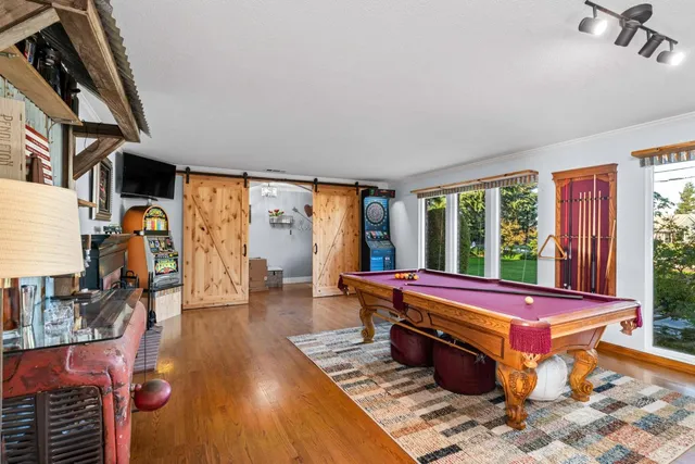 a living room with furniture a flat screen tv and a window