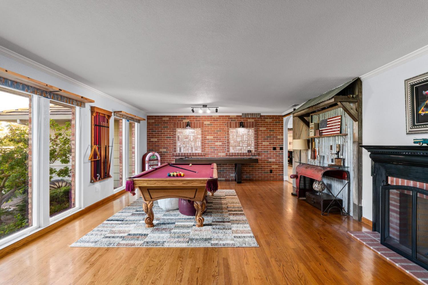 13791 Castle Road Manteca, CA 95336 - Photo 14 of 96 a living room with furniture a fireplace and large windows