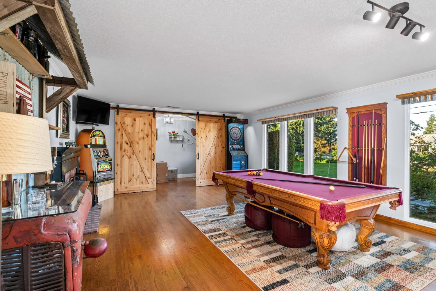 13791 Castle Road Manteca, CA 95336 - Photo 15 of 96 playroom with billiards, a barn door, wood finished floors, a textured ceiling, and track lighting
