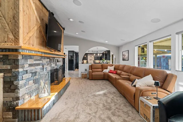 a bathroom with a granite countertop toilet sink and mirror