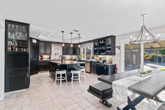 a view of a swimming pool with a yard and sitting area