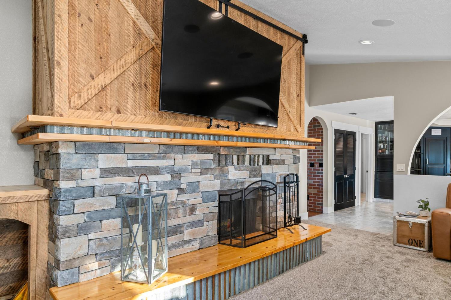 13791 Castle Road Manteca, CA 95336 - Photo 22 of 96 a living room with fireplace furniture and a flat screen tv