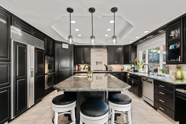 a view of a house with a swimming pool and sitting area