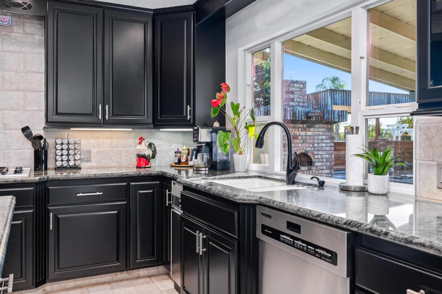 13791 Castle Road Manteca, CA 95336 - Photo 25 of 96 a kitchen with granite countertop a sink stainless steel appliances a counter space and wooden floor