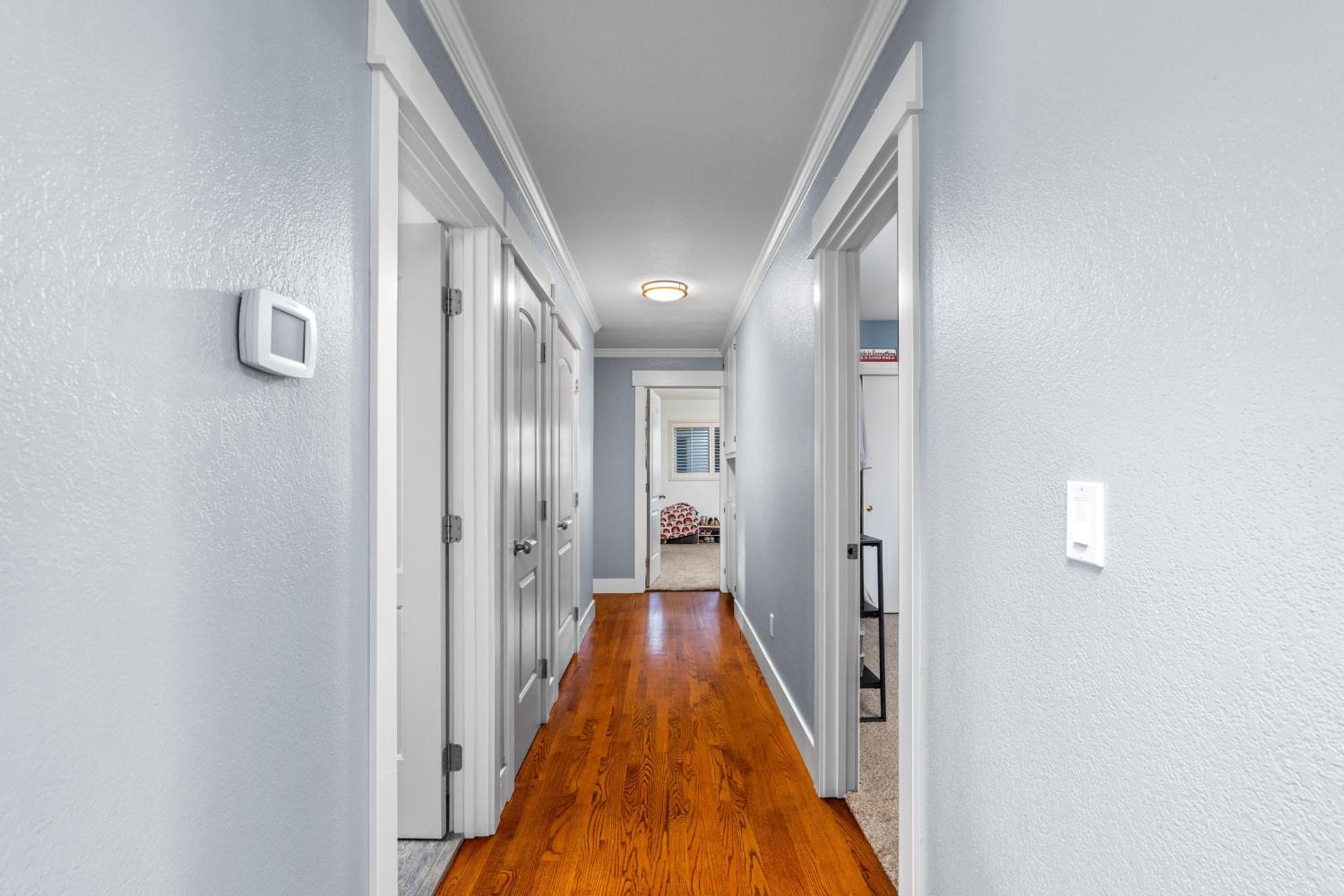 13791 Castle Road Manteca, CA 95336 - Photo 27 of 96 a view of a hallway with wooden floor and staircase