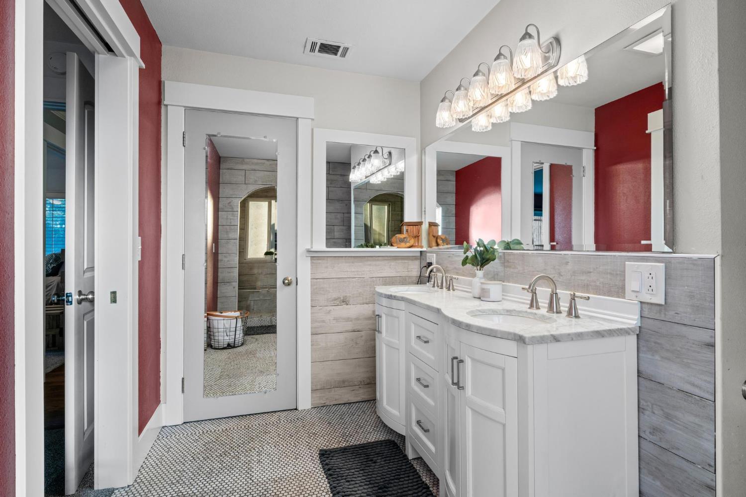13791 Castle Road Manteca, CA 95336 - Photo 32 of 96 bathroom with double vanity, light tile patterned floors, and tiled shower