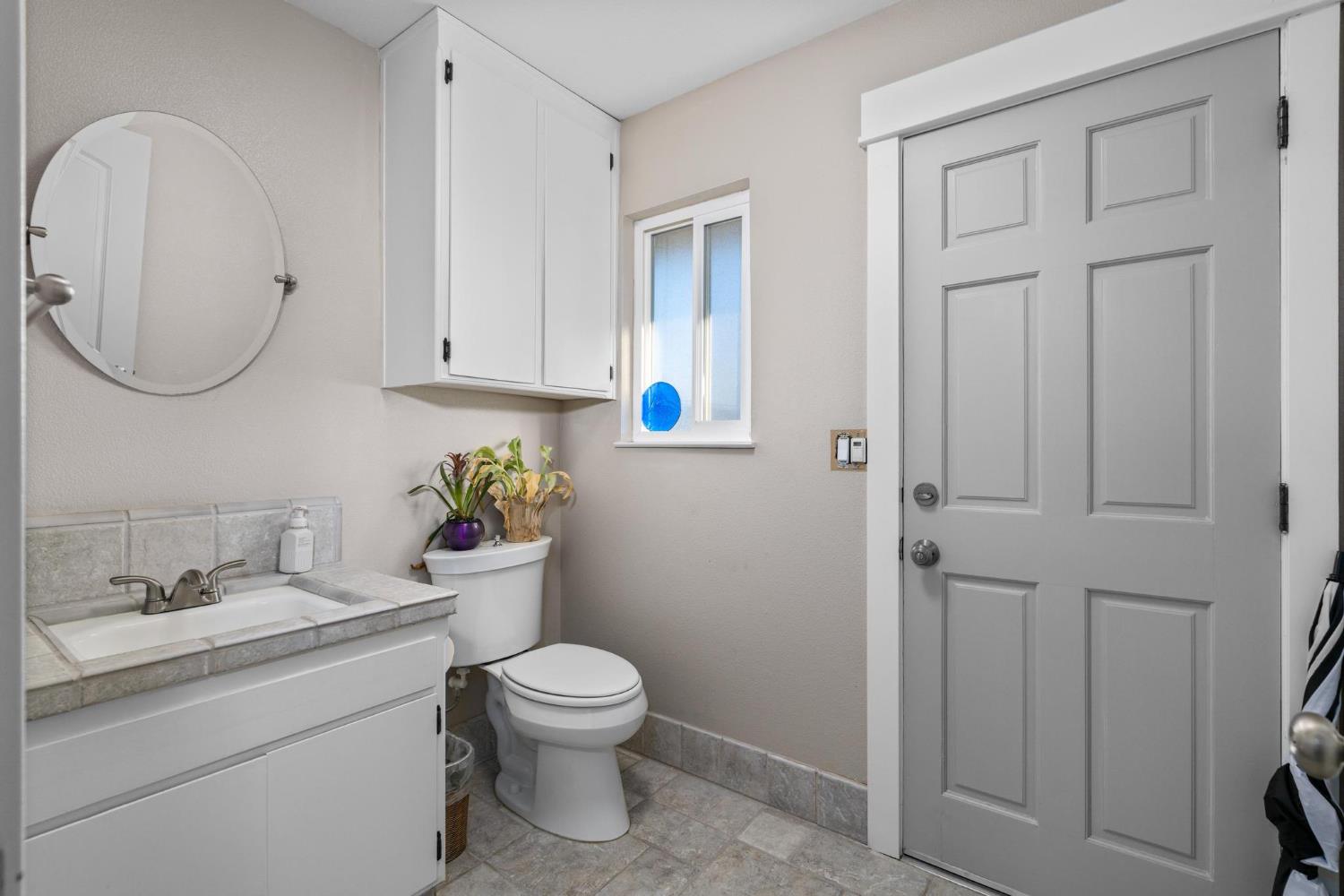 13791 Castle Road Manteca, CA 95336 - Photo 39 of 96 a bathroom with a toilet sink and mirror