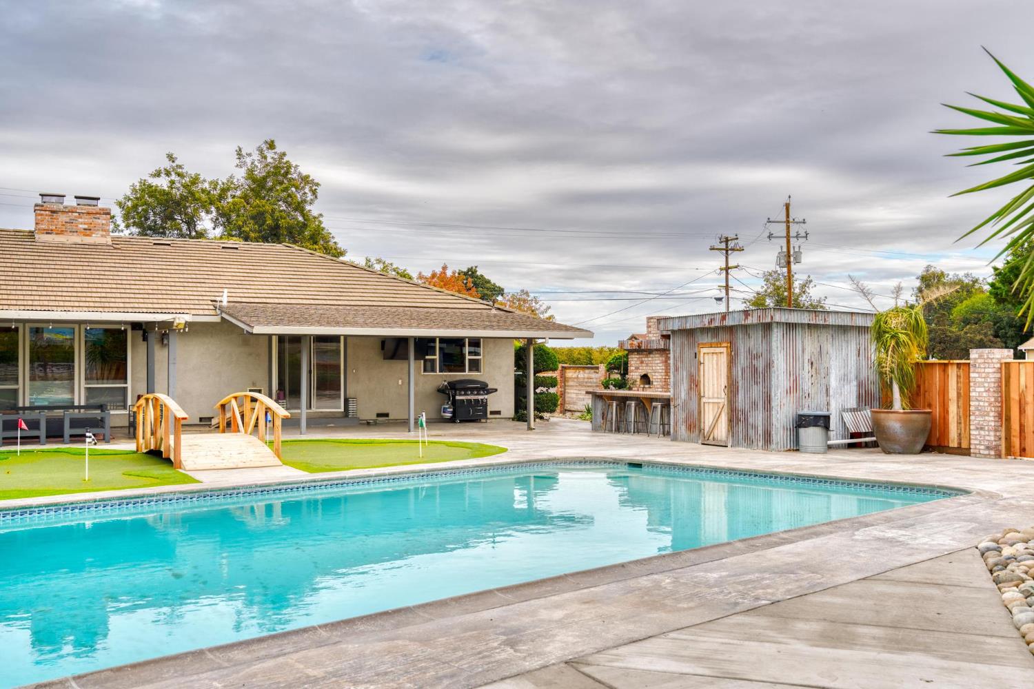 13791 Castle Road Manteca, CA 95336 - Photo 40 of 96 a view of a house with swimming pool and a yard