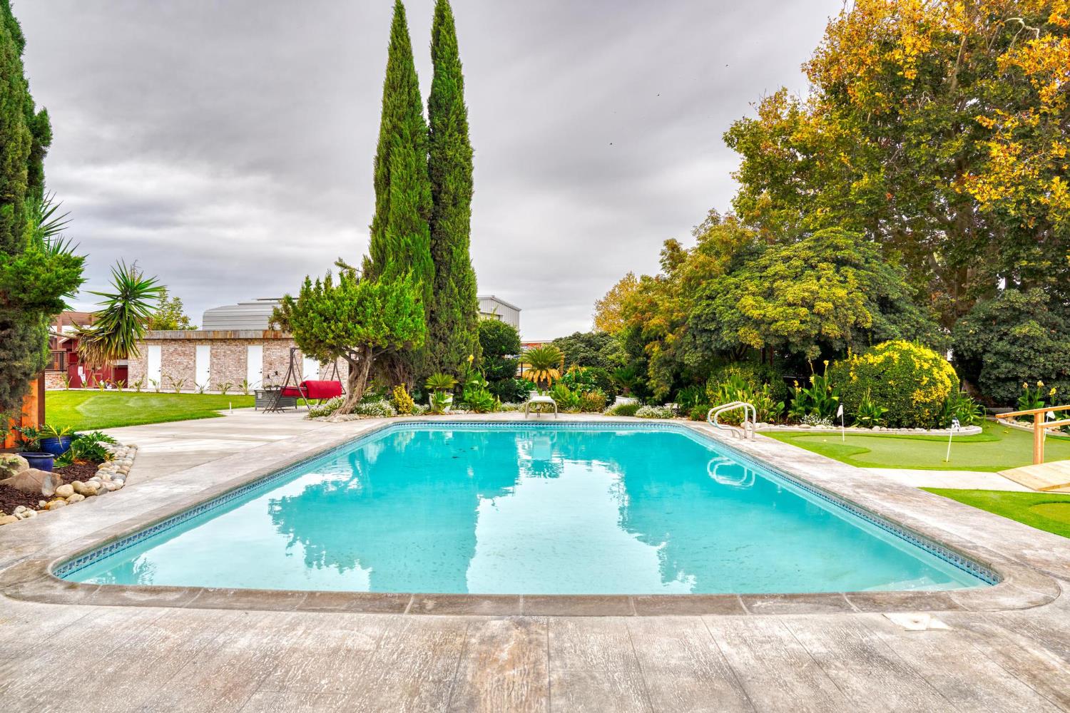 13791 Castle Road Manteca, CA 95336 - Photo 41 of 96 a view of a swimming pool with a yard and sitting area