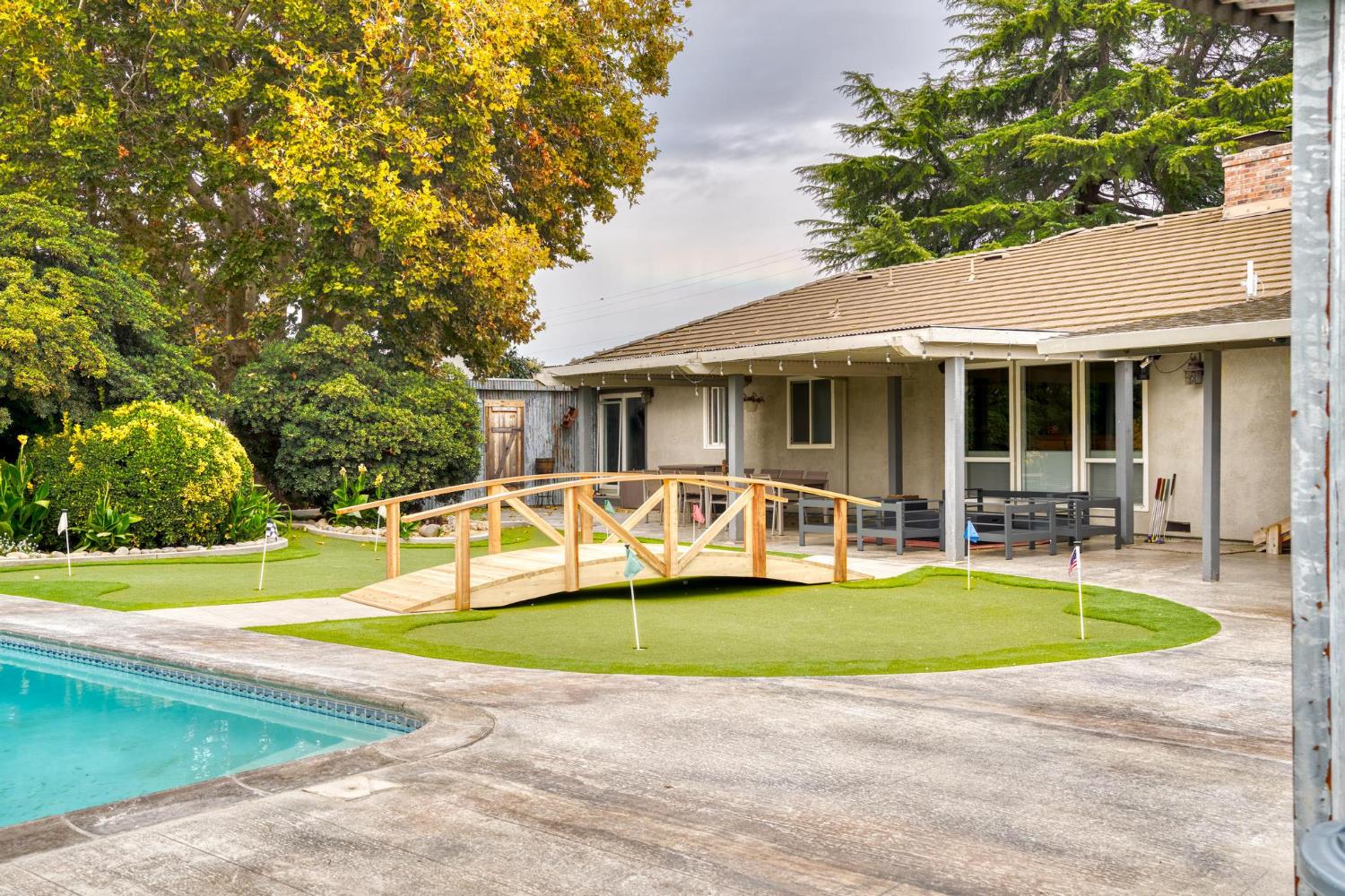 13791 Castle Road Manteca, CA 95336 - Photo 42 of 96 a view of a house with a swimming pool and sitting area