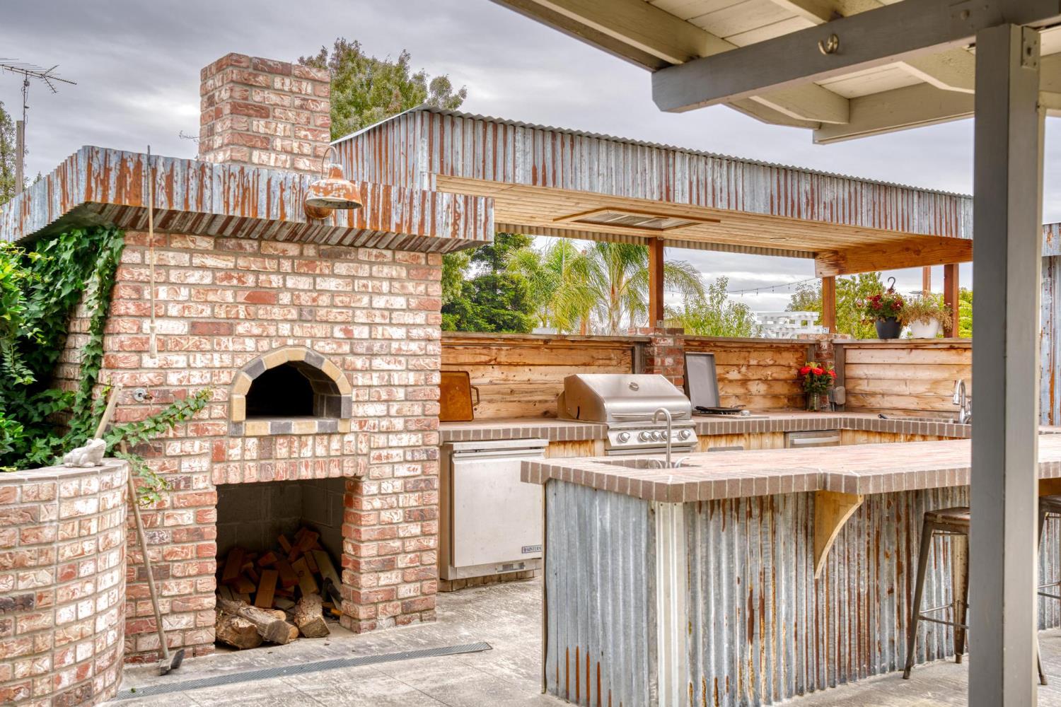 13791 Castle Road Manteca, CA 95336 - Photo 46 of 96 view of patio / terrace with a wood burning pizza oven, grill and a pergola