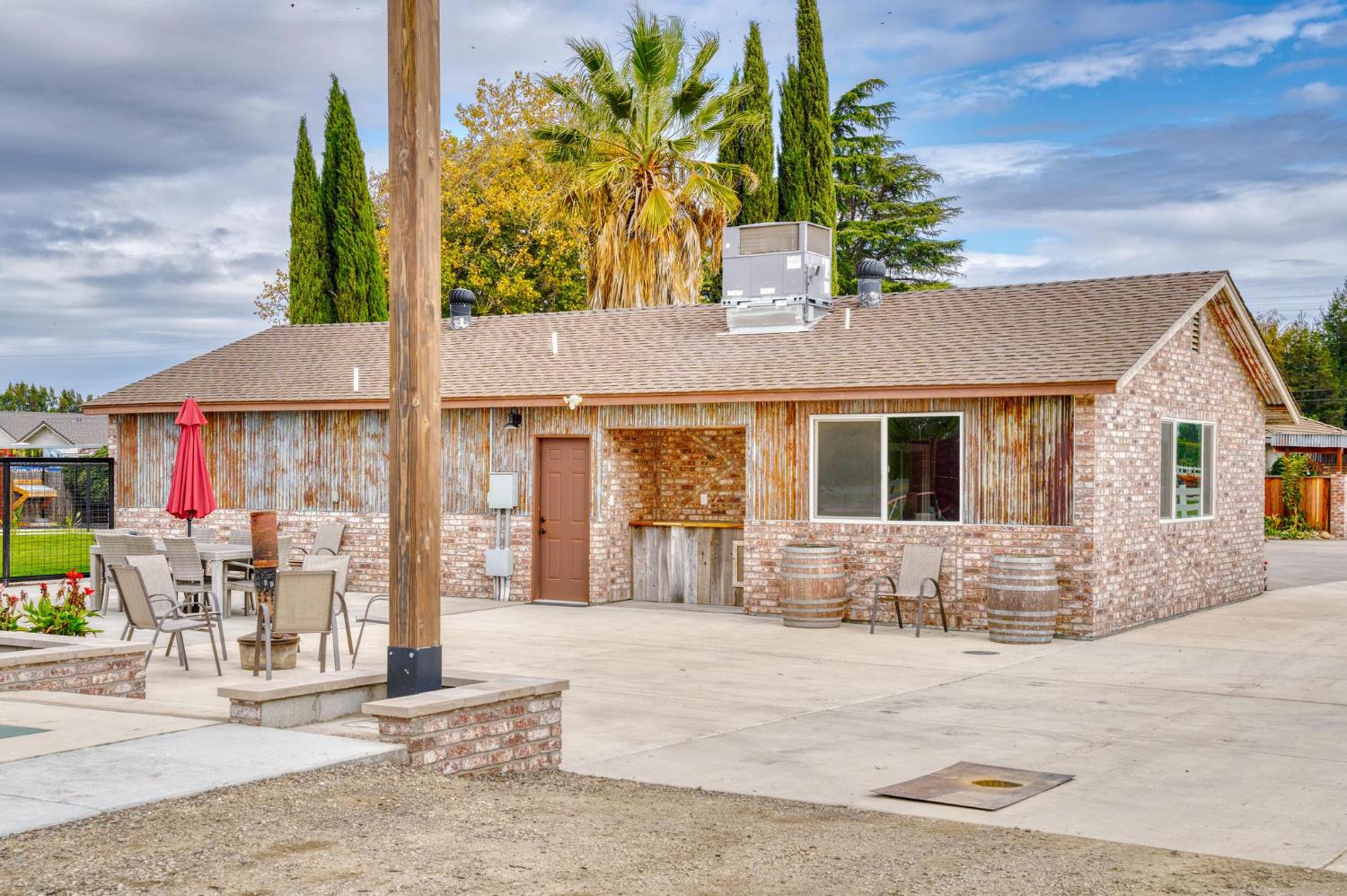 13791 Castle Road Manteca, CA 95336 - Photo 60 of 96 back of ADU with a shingled roof, a patio area, and brick siding