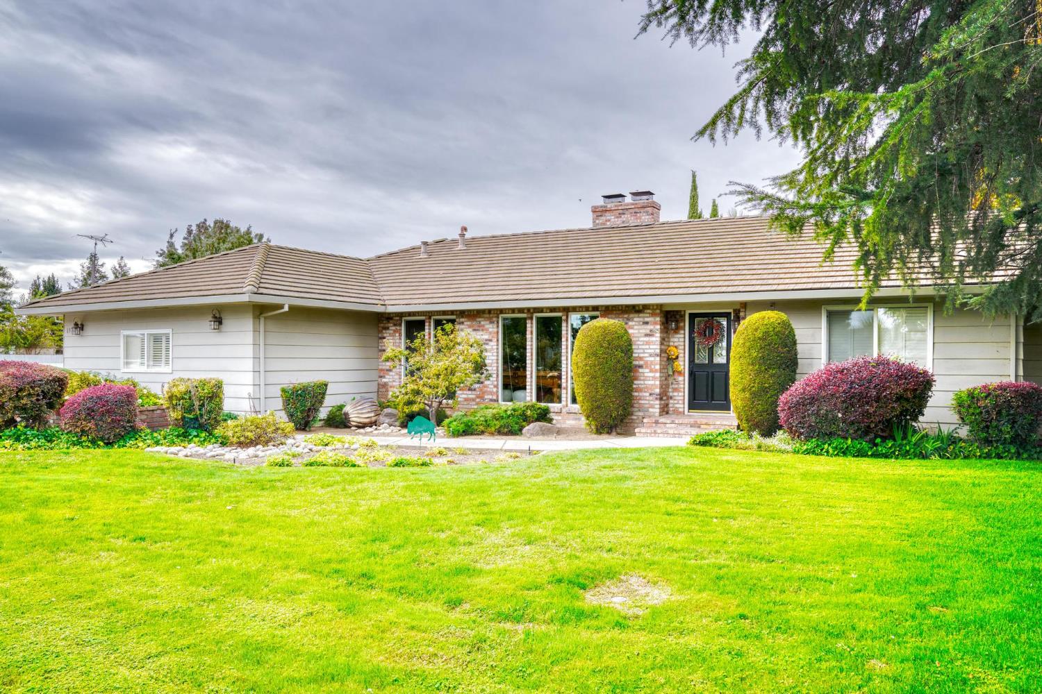 13791 Castle Road Manteca, CA 95336 - Photo 9 of 96 a front view of a house with garden and porch