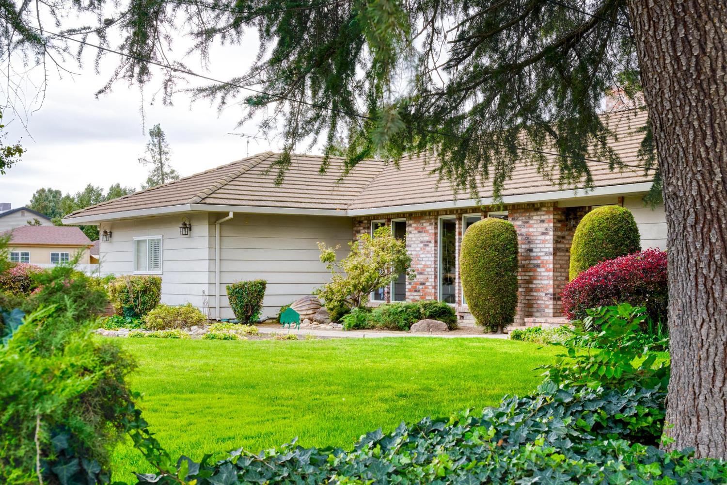 13791 Castle Road Manteca, CA 95336 - Photo 10 of 96 view of front of property featuring a front lawn and brick siding