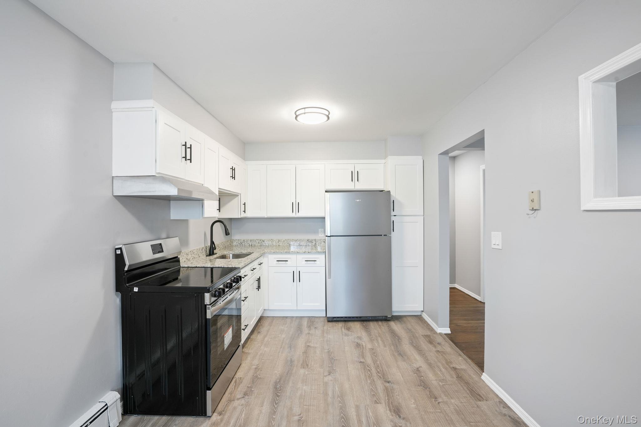 2710 South Road, Unit C6 Poughkeepsie, NY 12601 - Photo 11 of 19 a kitchen with a sink a refrigerator a stove and cabinets
