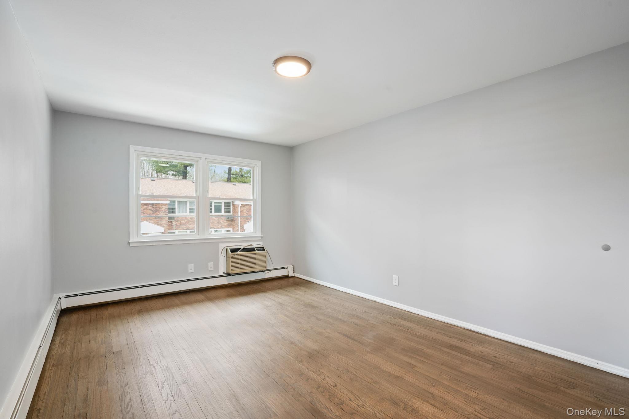 2710 South Road, Unit C6 Poughkeepsie, NY 12601 - Photo 15 of 19 an empty room with wooden floor and windows