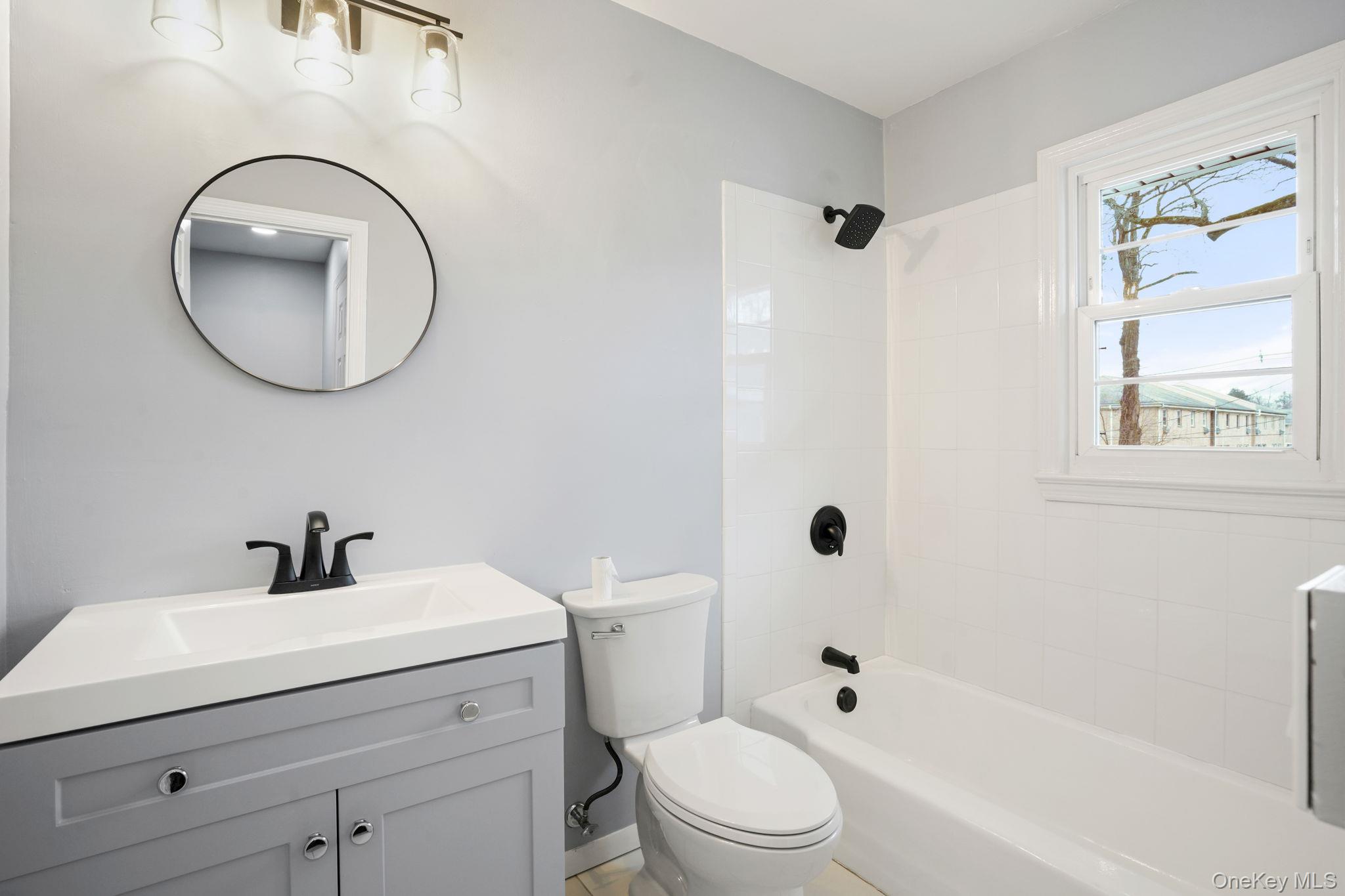 2710 South Road, Unit C6 Poughkeepsie, NY 12601 - Photo 16 of 19 a bathroom with a toilet a sink a mirror and a bathtub