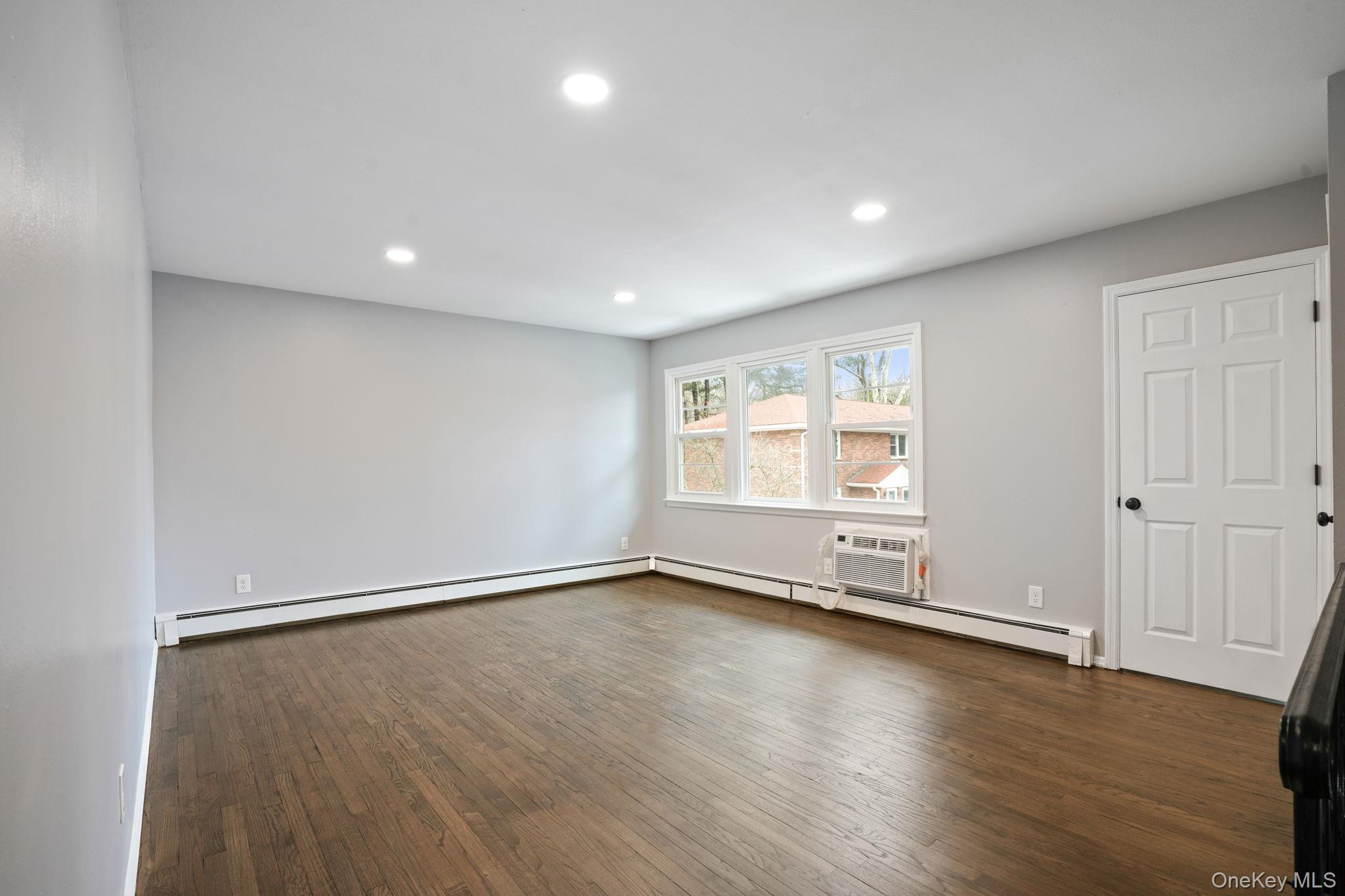 2710 South Road, Unit C6 Poughkeepsie, NY 12601 - Photo 3 of 19 an empty room with wooden floor and windows