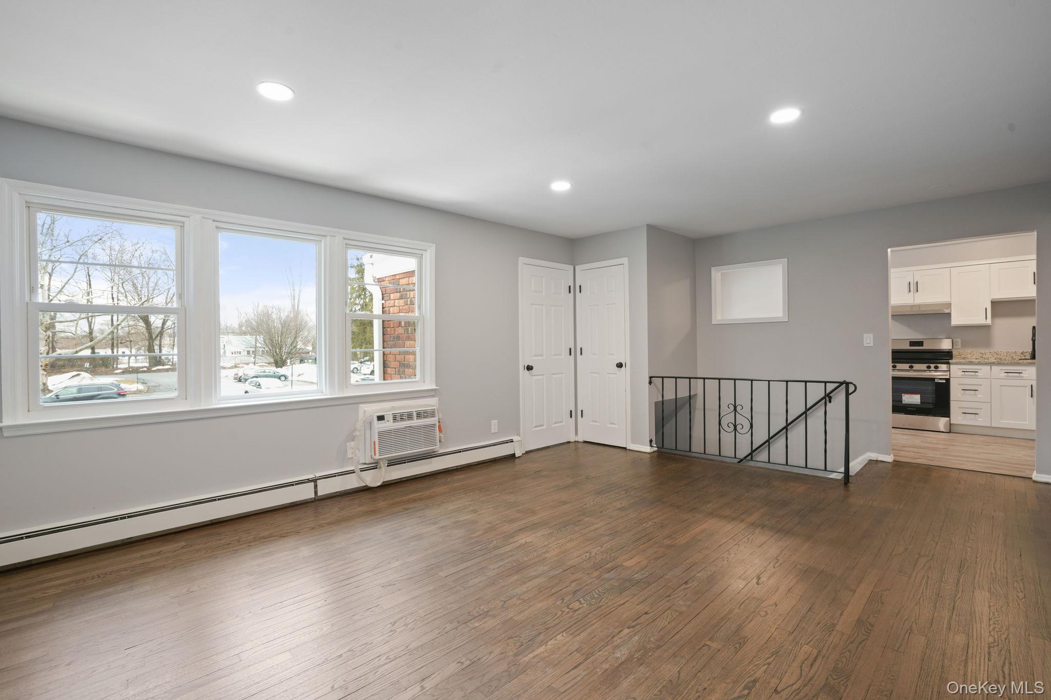 2710 South Road, Unit C6 Poughkeepsie, NY 12601 - Photo 4 of 19 an empty room with wooden floor and windows
