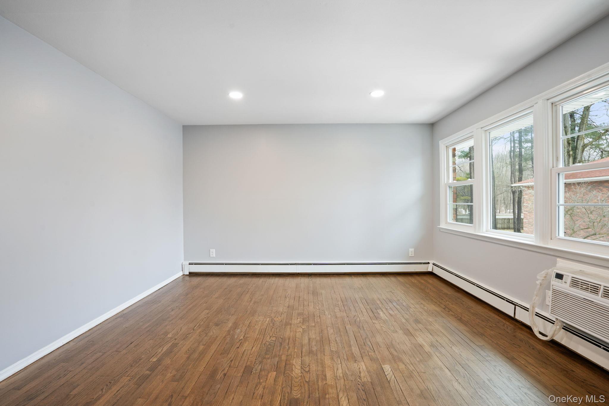 2710 South Road, Unit C6 Poughkeepsie, NY 12601 - Photo 7 of 19 an empty room with wooden floor and windows