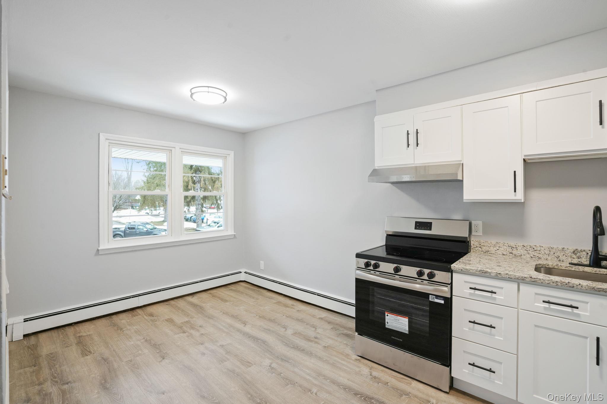 2710 South Road, Unit C6 Poughkeepsie, NY 12601 - Photo 8 of 19 a kitchen with granite countertop a stove a sink and a window