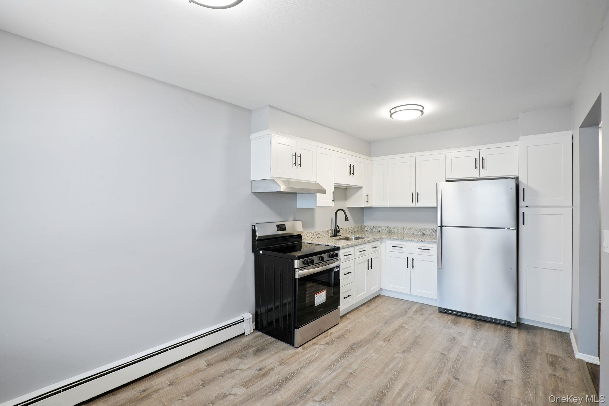 2710 South Road, Unit C6 Poughkeepsie, NY 12601 - Photo 10 of 19 a kitchen with a refrigerator and a stove top oven