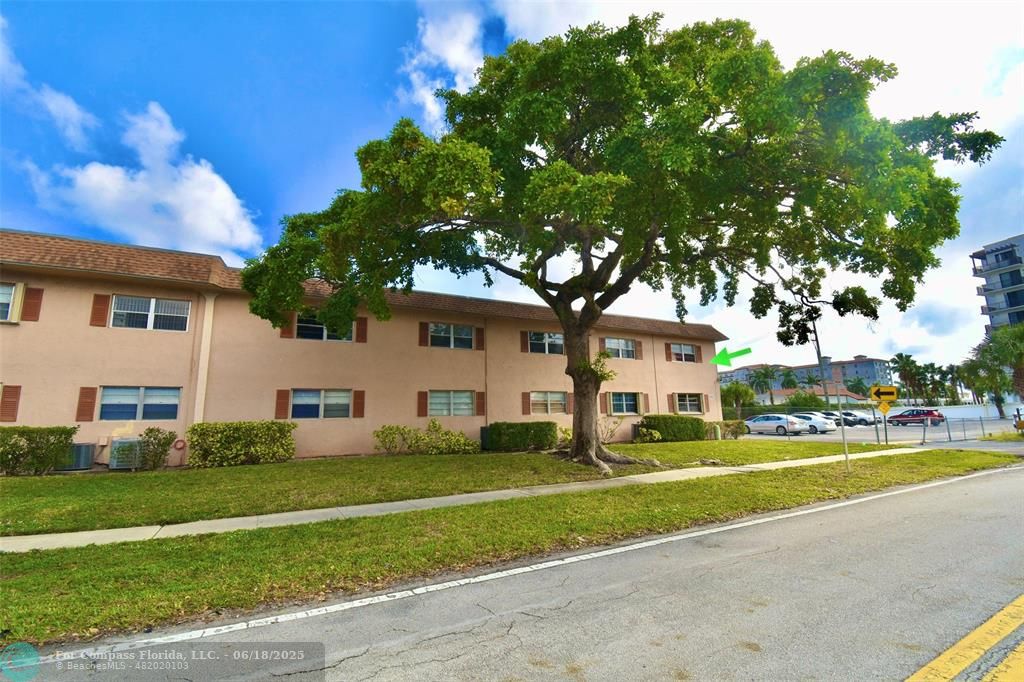 650 Southwest 2nd Avenue, Unit 256 Boca Raton, FL 33432 - Photo 1 of 13 a front view of a house with a garden and trees