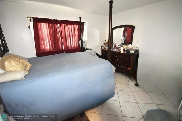 a bedroom with a bed and dresser