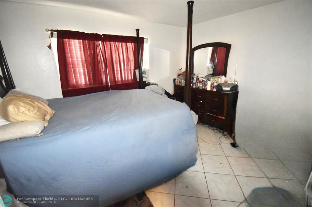 650 Southwest 2nd Avenue, Unit 256 Boca Raton, FL 33432 - Photo 12 of 13 a bedroom with a bed and dresser