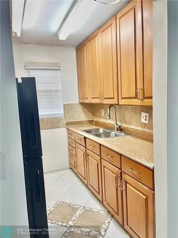 a bathroom with a granite countertop sink and a bathtub