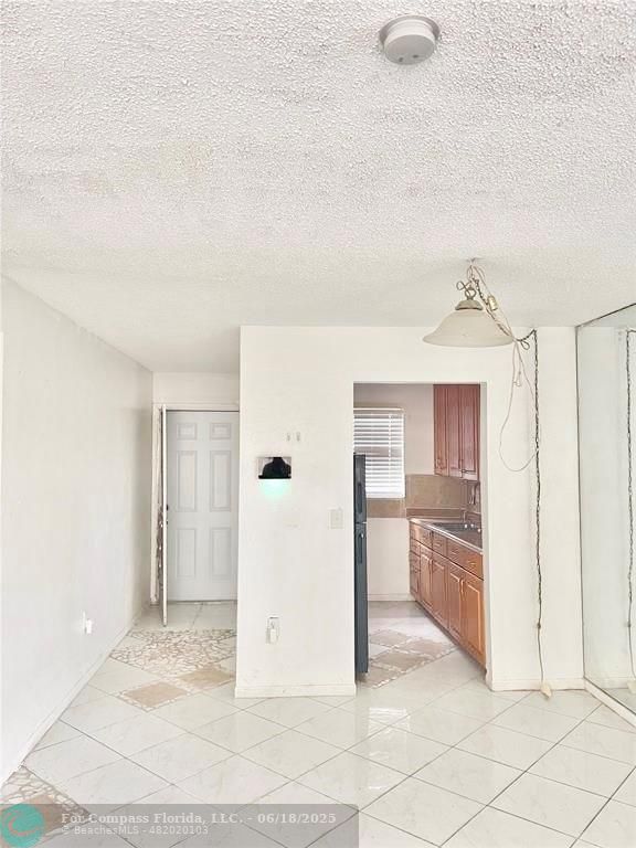 650 Southwest 2nd Avenue, Unit 256 Boca Raton, FL 33432 - Photo 7 of 13 a view of a kitchen with refrigerator and more cabinets